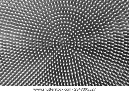 An image with black and white dots on  background in 3D relief. Abstract dotted. Halftone radial pattern