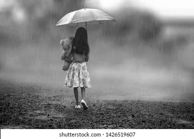 girl walking alone in rain
