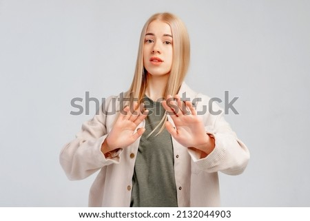 Image of blonde girl express disgust or dislike, grimacing from aversion, refusing, rejecting smth bad, stands against grey background. Social distancing Stock foto © 