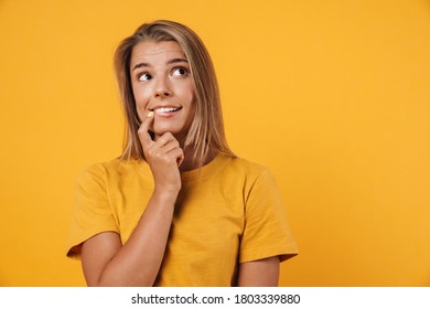 Image of blonde joyful woman smiling and looking aside isolated over yellow background - Shutterstock ID 1803339880