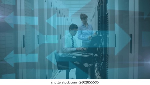 Image of blue arrows over man and woman checking computer servers. digital interface global connection and communication concept digitally generated image.