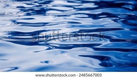A image of blue ocean waves featuring a water surface in detail
