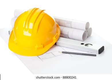 Image Of  Blueprints With Level Pencil And Hard Hat On Table