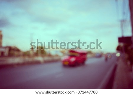 image of blur car on road in evening for background usage . (vintage tone image)