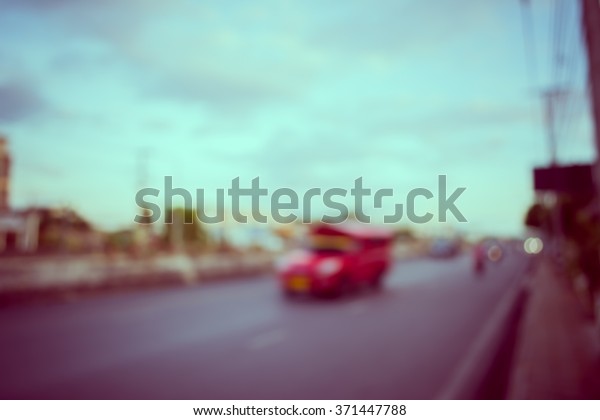image of blur car on road in evening for\
background usage . (vintage tone\
image)