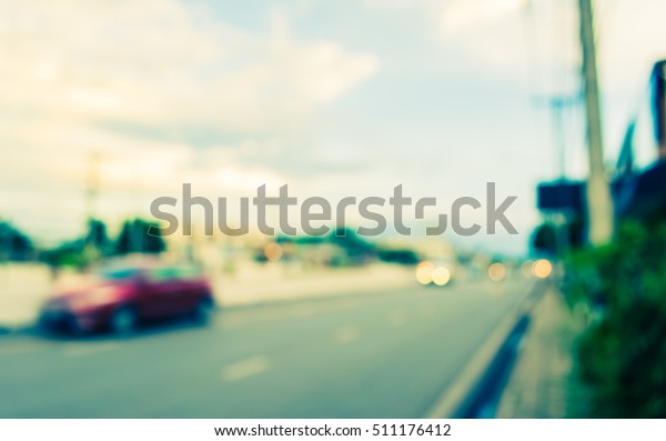 image of blur car on road in evening time for\
background usage. (vintage\
tone)