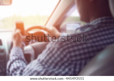 image of blur Concept of dangerousman used cell phone while driving are dangerous for other people,blur image,transportation and vehicle concept - man using phone while driving the car
