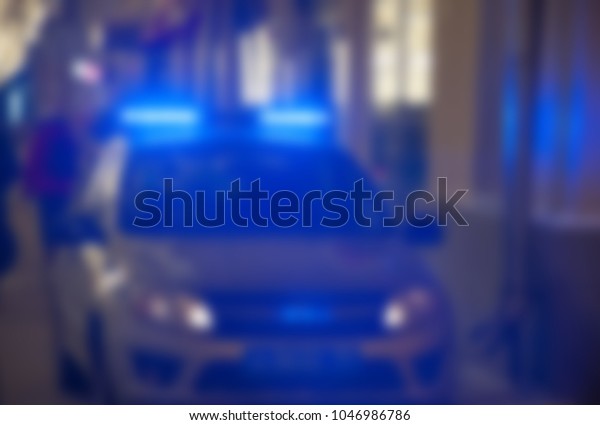 Image of blur police car with flasher\
blue lights in night time for background\
usage