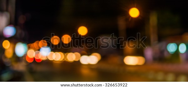 image of blur street and\
billboard with warm colorful lights in night time for background\
usage .