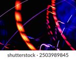 The image is a blurry, colorful representation of a roller coaster. The bright colors and blurred lines create a sense of motion and excitement, evoking the feeling of being on a roller coaster