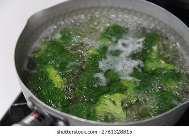 Image of boiling broccoli in a pot.