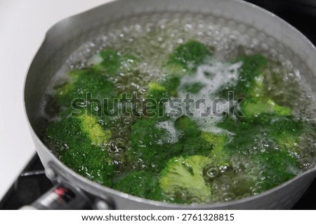 Image of boiling broccoli in a pot.