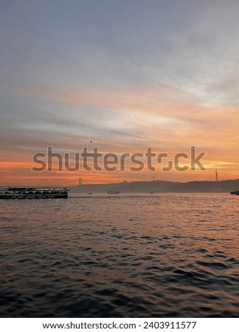 Image of the Bosphorus with the Bosphorus Bridge in the background, combining the European and Anatolian continents, taken at a beautiful sunrise from Besiktas, Istanbul, Turkey in vertical format.