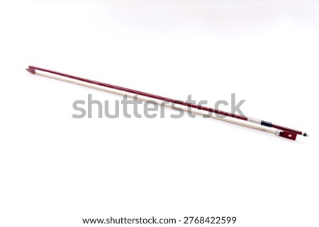 Image of bow to play violin, a string instrument typically used in classical and folk music on black background. 
