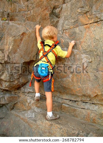 Image of boy cragsman of five years, training to ascend without insurance.
