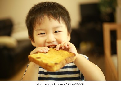 Image Of A Boy Eating Bread 
