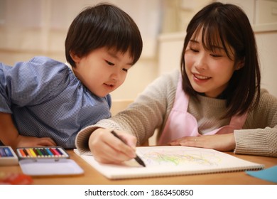 Image Of A Boy And A Nursery Teacher Drawing