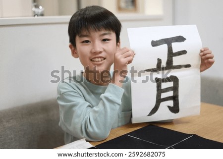 Image of a boy practicing calligraphy
