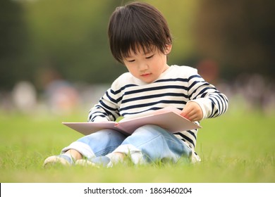 Image Of A Boy Reading A Book