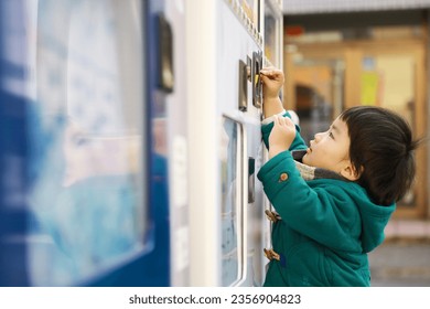 Image of a boy using a vending machine