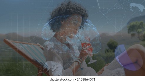Image of brain, globes and data processing over biracial woman drinking cocktail on beach. Global communication, health, wellbeing and digital interface concept digitally generated image.