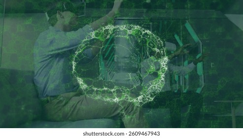 Image of brain scan and medical data processing on interface, over man and woman in vr headsets. global medical research technology and digital interface concept, digitally generated image.