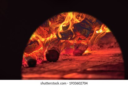 Image of a brick pizza oven with fire and flame