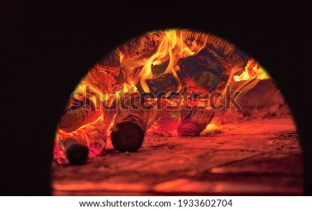 Image of a brick pizza oven with fire and flame