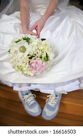 An Image Of A Bride Dressed In Gown And Tennis Shoes