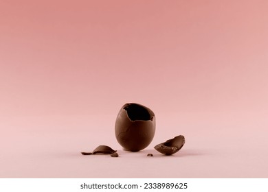 Image of broken chocolate easter egg and copy space on pink background. Easter, religion, tradition and celebration concept. - Powered by Shutterstock