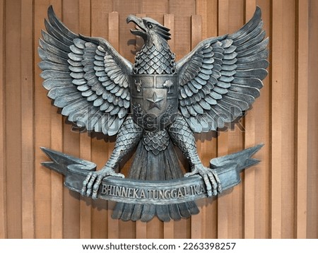 
image of a Bronze statue of Garuda Pancasila, the Republic of Indonesia's national symbol. The meaning of Bhinneka Tunggal Ika is 