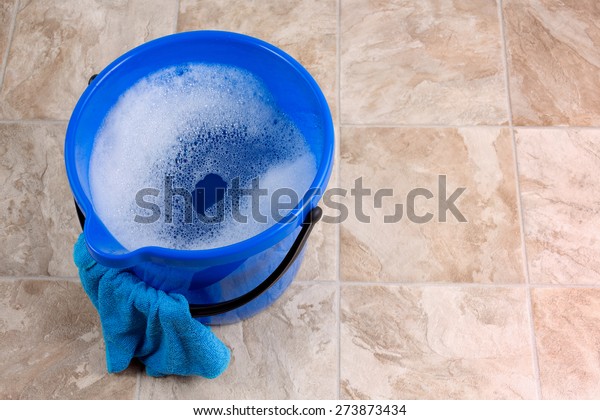 Image of a\
bucket with rag and water for\
cleaning
