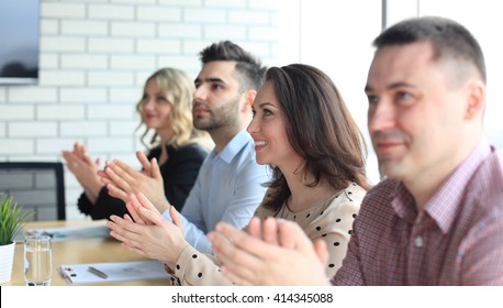 Image of business colleagues applauding in the end of the conference sitting in a line - Shutterstock ID 414345088
