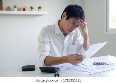 Image Of A Business Man With Financial Concerns. Think Hard About Paying Off Credit Card Debt, House Rent, And Family Expenses. Financial Problem Concept