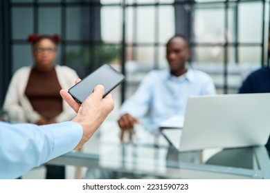 image of a business man with a smartphone standing in the office - Shutterstock ID 2231590723