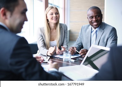 Image of business people listening and talking to their colleague at meeting - Shutterstock ID 167791949