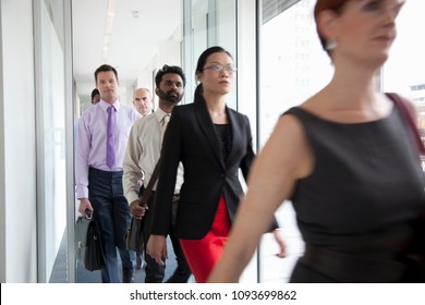 Image Of Business People Rushing Past Camera