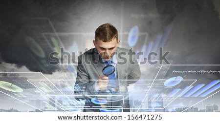 Image of businessman examining objects with magnifier