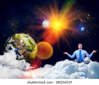 image of a businessman meditating in the clouds in space