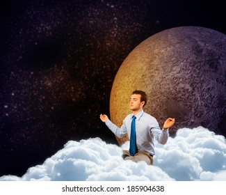 image of a businessman meditating in the clouds in space
