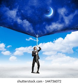 Image Of Businessman Pulling Banner With Illustration. Day And Night Concept