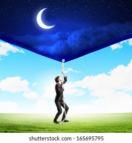 Image Of Businessman Pulling Banner With Illustration. Day And Night Concept