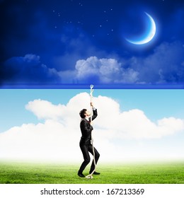 Image Of Businessman Pulling Banner With Illustration. Day And Night Concept