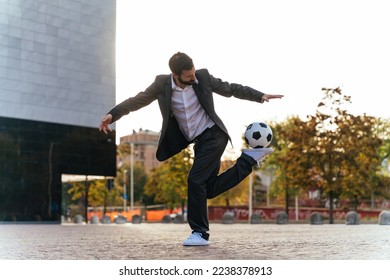 Image of a businessman and soccer freestyle player making tricks with the ball on the street. Concept about sport and business people	 - Powered by Shutterstock