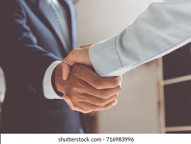 Image Of Businessmen Is Shaking Hands, Businessman Agrees To Be The Same Cooperate In Order To Step Through Away The Bad Economy Together.