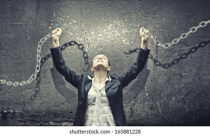 Image of businesswoman in anger breaking metal chain - Powered by Shutterstock