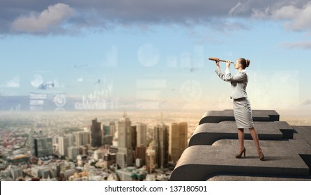 Image of businesswoman looking in telescope standing a top of building