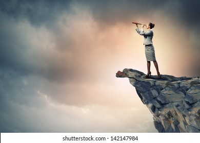 Image of businesswoman looking in telescope standing a top of rock - Powered by Shutterstock - Get 15% off with code: PIKWIZARD15