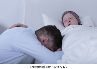 Image Of Cancer Child Comforting Despair Father