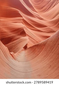 The image captures the flowing, intricate patterns of red sandstone formed by natural erosion in a canyon setting.